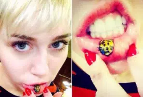Celebrity Miley Cyrus with an inner lip tattoo